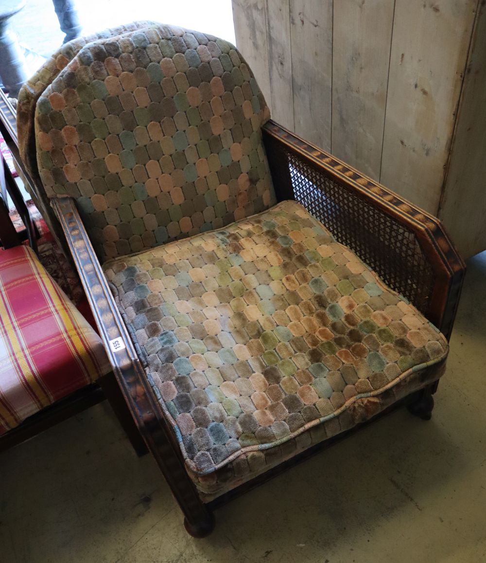 A pair of early 20th century oak bergere armchairs